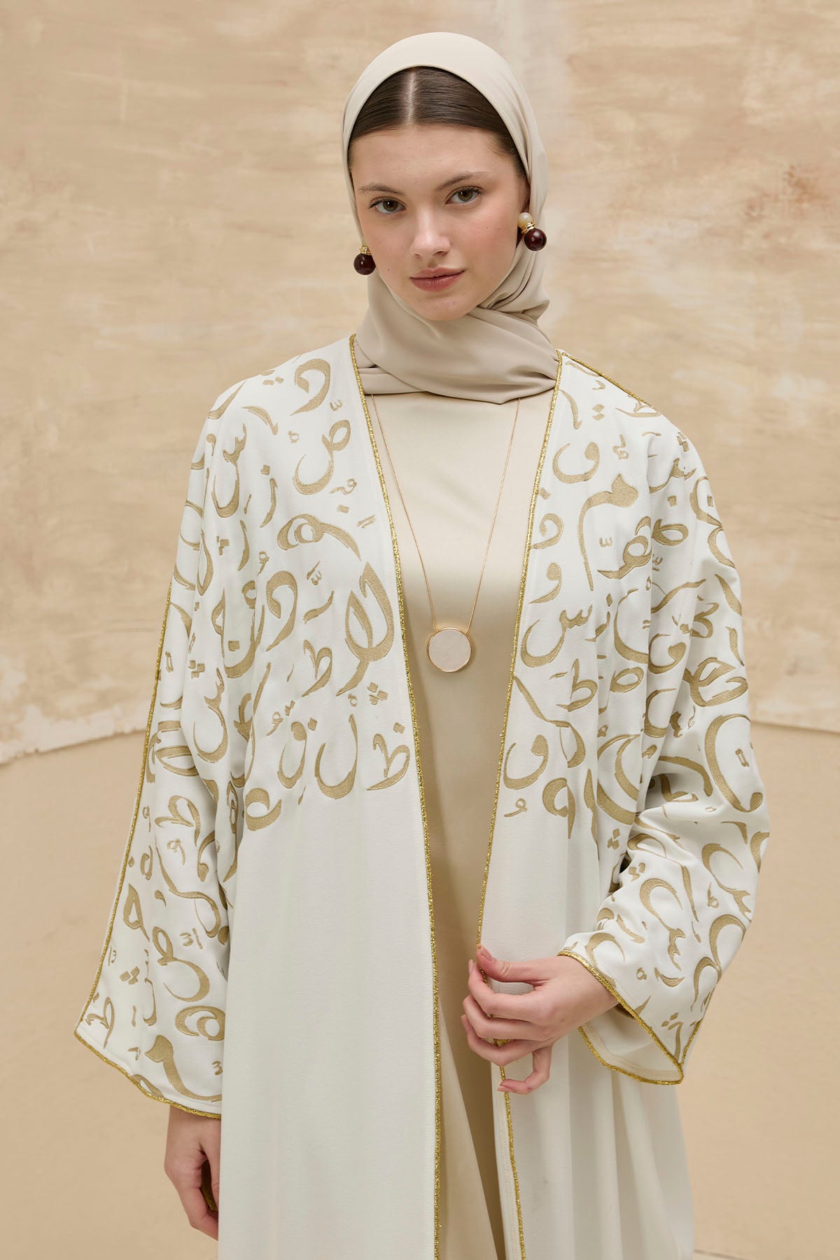 Kaligrafik Desenli Üst Form Omuz ve Kol Biyeli Uzun Beyaz Abaya